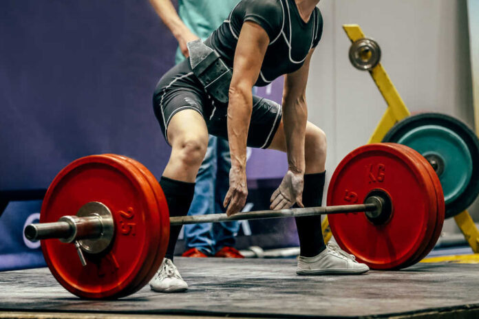 Female,Powerlifter,Preparing,For,Deadlift,Of,Barbell,During,Competition,Of