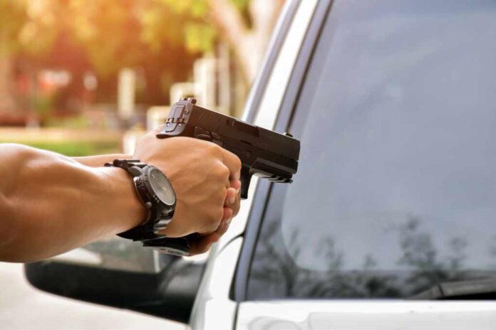 Automatic,9mm,Pistol,Holding,In,Hand,In,Front,Of,The