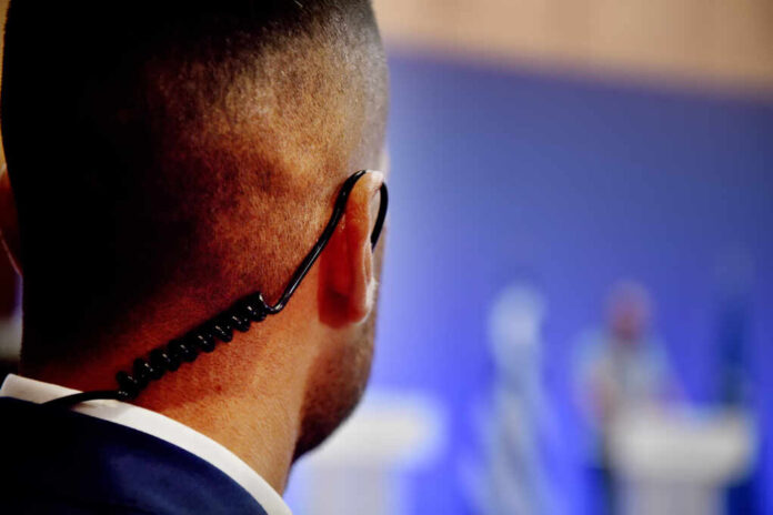 A,Security,Guard,Wears,An,Ear,Headset,During,A,Government