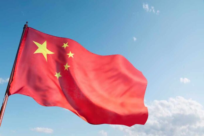 A,Red,And,Yellow,Chinese,Flag,Is,Flying,In,The