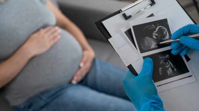 Gynecologist,Looks,At,An,Ultrasound,Of,A,Pregnant,Woman.