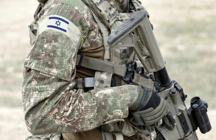 Soldier,With,Assault,Rifle,And,Flag,Of,Israel,On,Military
