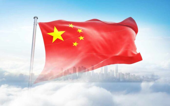 China,Flag,Wavering,In,Beautiful,Clouds,With,Building,Skyline.,The