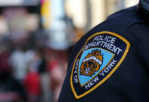 Close-up of a New York City police badge on an officers uniform