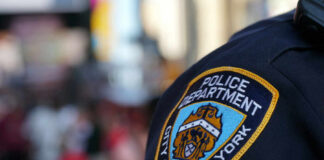 Close-up of a New York City police badge on an officers uniform