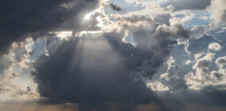 Dramatic clouds with sunlight rays over the ocean