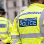 Uniformed Metropolitan Police officers standing in a public area
