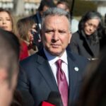 A politician speaking to the media during a press conference