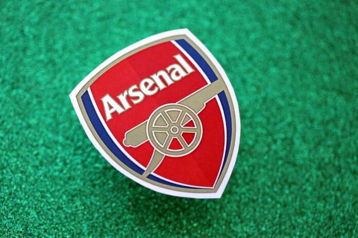 Arsenal football club logo on a green glitter background