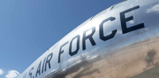 Close-up of a U.S. Air Force aircraft with a shiny metallic surface against a blue sky