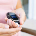 Person using a blood glucose meter to check their levels