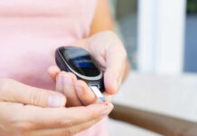 Person using a blood glucose meter to check their levels
