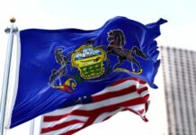 Pennsylvania state flag waving alongside the American flag