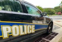 Side view of a Baltimore police car parked near a street