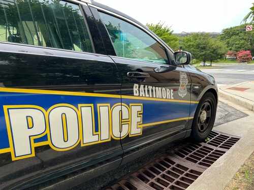 Side view of a Baltimore police car parked near a street