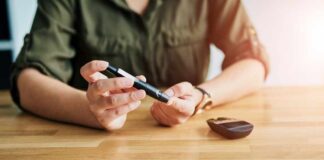 Person using a blood glucose meter and a pen device for diabetes management