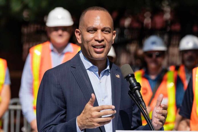 A man speaking at a podium with construction workers in the background