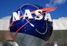 NASA logo displayed on a large blue globe against a clear sky