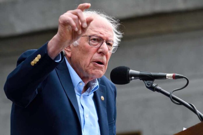 A man passionately speaking at a microphone during a rally
