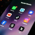 Close-up of a smartphone screen displaying various social media app icons