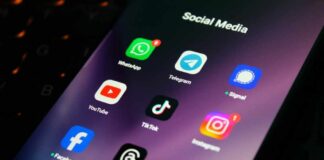 Close-up of a smartphone screen displaying various social media app icons