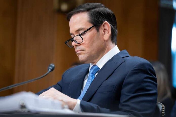 Individual in a suit reviewing documents during a senate hearing