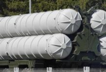 Close-up of a military missile system with cylindrical launchers