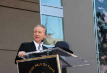 A man speaking at a podium during a Hollywood Walk of Fame ceremony