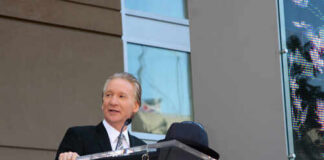 A man speaking at a podium during a Hollywood Walk of Fame ceremony