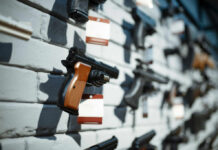 Governor’s Gun Laws: Crushing Freedom or Ensuring Safety? A variety of handguns displayed on a wall with price tags