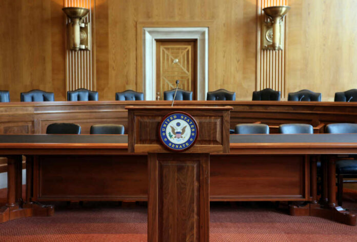 Wooden podium with the United States Senate seal in an empty Senate chamber