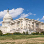 The U.S. Capitol building with a clear blue sky in the background