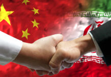 China’s Sneaky Missile Aid to Iran – Exposed! Handshake between two individuals with Chinese and Iranian flags in the background