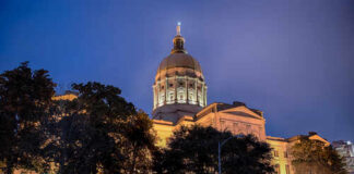 Trump’s Endorsement SAVES GOP’s Fragile Majority State capitol building illuminated at night with a prominent dome