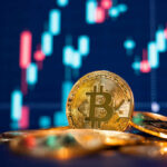 Close-up of Bitcoin coins in front of a trading chart