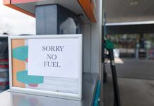 Europe CHOKES — Critical Supply Line Severed Sign at a gas station indicating no fuel available