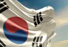 Waving flag of South Korea against a blue sky