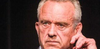 Close-up of a man in a suit with a serious expression