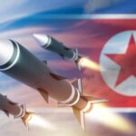 Three missiles launching against a backdrop of the North Korean flag