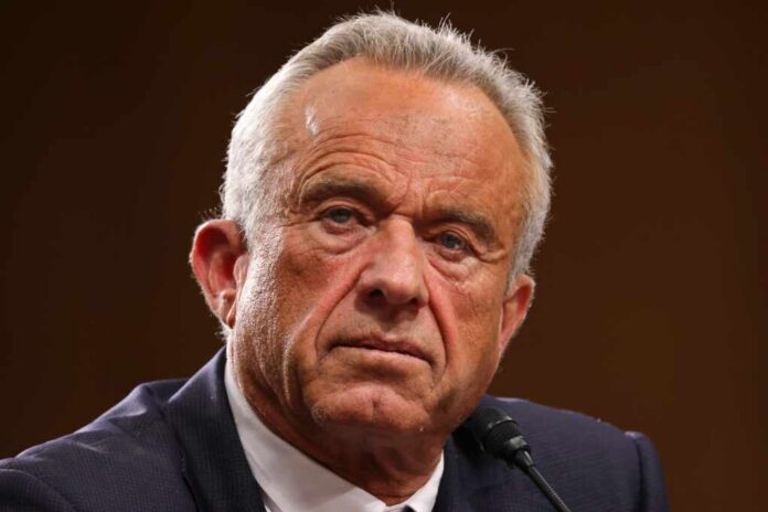 Close-up of a serious-looking man speaking into a microphone