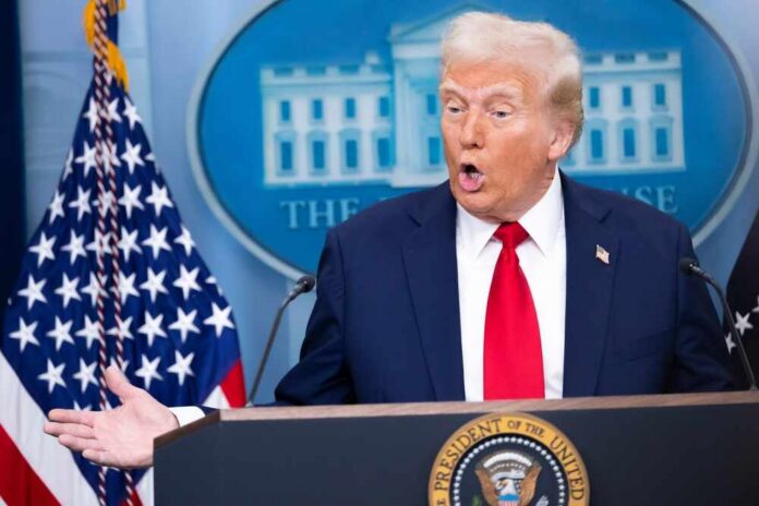 A man speaking at a podium during a press conference at the White House