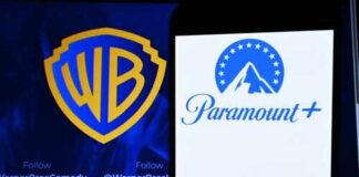 Logos of Warner Bros and Paramount Plus displayed on a screen