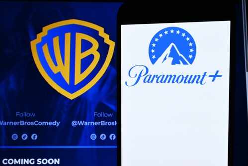 Logos of Warner Bros and Paramount Plus displayed on a screen