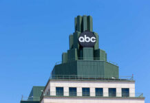 Top of a building featuring a prominent ABC logo against a clear blue sky