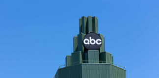 Top of a building featuring a prominent ABC logo against a clear blue sky