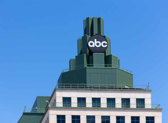 Top of a building featuring a prominent ABC logo against a clear blue sky
