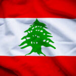Flag of Lebanon featuring a green cedar tree on a white stripe between red stripes