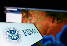 FEMA logo in front of a geographic map on a computer screen