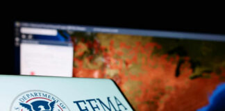 FEMA logo in front of a geographic map on a computer screen