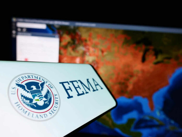 FEMA logo in front of a geographic map on a computer screen